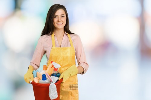 Oven cleaner working in a compact SE4 kitchen with careful access